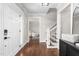 Inviting entryway with hardwood floors, staircase, and a view into the adjacent living space at 213 Brompton Ct, Burlington, NC 27215