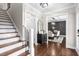 Elegant hallway featuring hardwood floors, a staircase and a dining room at 213 Brompton Ct, Burlington, NC 27215