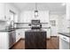 Modern kitchen with white cabinetry, black countertops and stainless appliances at 213 Brompton Ct, Burlington, NC 27215