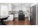Bright, updated kitchen features white cabinets, island, and stainless appliances at 213 Brompton Ct, Burlington, NC 27215