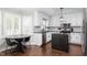 Modern kitchen features white cabinets, island, and stainless steel appliances at 213 Brompton Ct, Burlington, NC 27215