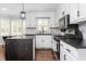 Bright kitchen features white cabinets, stainless steel appliances, and a large island with a contrasting countertop at 213 Brompton Ct, Burlington, NC 27215