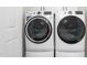 Modern laundry room featuring front-load washer and dryer with smart technology at 213 Brompton Ct, Burlington, NC 27215
