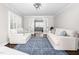 Bright living room featuring two white sofas, blue rug, and French doors at 213 Brompton Ct, Burlington, NC 27215