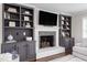 Fireplace with flanking built-in shelving units and a television at 213 Brompton Ct, Burlington, NC 27215