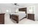 Spacious bedroom with dark wood furniture, ceiling fan, and carpeted floors at 213 Brompton Ct, Burlington, NC 27215