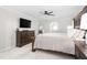 Bright main bedroom featuring a ceiling fan, large dresser, and neutral decor at 213 Brompton Ct, Burlington, NC 27215