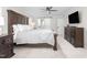 Spacious bedroom featuring a ceiling fan, tv, and ensuite bath with sliding barn door at 213 Brompton Ct, Burlington, NC 27215
