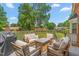 Outdoor patio area with ample seating space, a grill, and a view of the backyard at 213 Brompton Ct, Burlington, NC 27215