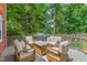 Outdoor patio area featuring a seating area, grill, and lush surrounding greenery at 213 Brompton Ct, Burlington, NC 27215