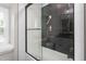 Modern glass enclosed shower with herringbone tile and bench at 213 Brompton Ct, Burlington, NC 27215
