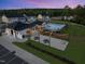 Aerial view of the community pool area with seating, picnic tables, and well-lit gathering spaces at 272 Meadowbark Bnd # 41, Garner, NC 27529