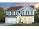 Charming two-story home featuring a welcoming front porch, complemented by blue shutters and a well-manicured lawn at 3205 Pelican Ln, Durham, NC 27703