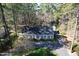 Aerial view of charming single-story home surrounded by mature trees and a paved driveway at 322 Gravley Dr, Rocky Mount, NC 27804