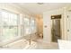Light-filled bathroom with large windows, a soaking tub, separate shower, and striped wallpaper at 322 Gravley Dr, Rocky Mount, NC 27804