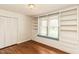Bright bedroom features hardwood floors, custom built-in shelving, and window seat at 322 Gravley Dr, Rocky Mount, NC 27804