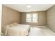 Cozy bedroom featuring a queen size bed with patterned wallpaper and shuttered windows at 322 Gravley Dr, Rocky Mount, NC 27804