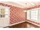 Cozy breakfast nook with floral wallpaper, a bay window, and brick floors at 322 Gravley Dr, Rocky Mount, NC 27804