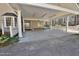 Spacious carport with white pillars, concrete floor, and access to the home's entrance, surrounded by greenery at 322 Gravley Dr, Rocky Mount, NC 27804