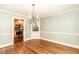 Elegant dining room featuring hardwood floors, a chandelier, and decorative molding at 322 Gravley Dr, Rocky Mount, NC 27804