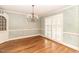 Elegant dining room featuring hardwood floors, decorative chandelier, and built-in cabinets for refined dining experience at 322 Gravley Dr, Rocky Mount, NC 27804