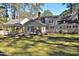 Beautiful home featuring a spacious backyard, a classic chimney, and complemented by a covered outdoor area at 322 Gravley Dr, Rocky Mount, NC 27804