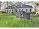 Charming single-story home featuring lush landscaping and a prominent address sign at 322 Gravley Dr, Rocky Mount, NC 27804