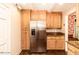 Kitchen featuring stainless steel refrigerator, wooden cabinetry, and granite countertops at 322 Gravley Dr, Rocky Mount, NC 27804