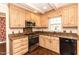 Well-lit kitchen featuring wooden cabinets, granite countertops, and modern appliances at 322 Gravley Dr, Rocky Mount, NC 27804