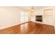 Living room with a fireplace, white built-in shelving, and hardwood floors at 322 Gravley Dr, Rocky Mount, NC 27804
