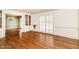 Inviting living room featuring hardwood floors, built-in cabinets, and shuttered windows, offering a bright and airy space at 322 Gravley Dr, Rocky Mount, NC 27804