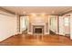Spacious living room with hardwood floors, fireplace, built-in shelving, and access to other rooms at 322 Gravley Dr, Rocky Mount, NC 27804