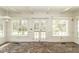 Bright sunroom features brick flooring, wainscotting, and many windows letting in natural light at 322 Gravley Dr, Rocky Mount, NC 27804