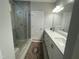 Elegant bathroom with dual sinks, white cabinets, quartz countertop, and a tiled shower at 325 Olde Liberty Dr, Youngsville, NC 27596