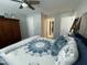 Well-lit bedroom features a decorative quilt, blue pillows, and an armoire for storage at 325 Olde Liberty Dr, Youngsville, NC 27596