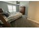 Bright bedroom showcasing a window with white shutters and a cozy quilt adorned bed at 325 Olde Liberty Dr, Youngsville, NC 27596