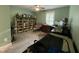 Bedroom features a desk area with built-in shelving and window with plantation shutters at 325 Olde Liberty Dr, Youngsville, NC 27596