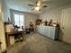 Bonus room boasts a ceiling fan, window with shutters, and storage with craft tables at 325 Olde Liberty Dr, Youngsville, NC 27596