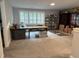 Carpeted bonus room with a sewing and craft table features storage and a window with blinds at 325 Olde Liberty Dr, Youngsville, NC 27596