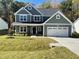 Charming two-story home featuring a spacious two-car garage and a well-manicured lawn at 325 Olde Liberty Dr, Youngsville, NC 27596