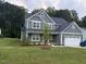 Charming two-story home with lush green lawn at 325 Olde Liberty Dr, Youngsville, NC 27596