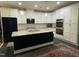 Modern kitchen features white cabinets, stainless steel appliances, and a large island with granite countertops at 325 Olde Liberty Dr, Youngsville, NC 27596