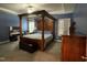 Main bedroom boasts a four-poster bed, plantation shutters, and elegant decor at 325 Olde Liberty Dr, Youngsville, NC 27596