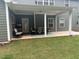 Inviting covered patio featuring an outdoor dining set, perfect for relaxing and entertaining at 325 Olde Liberty Dr, Youngsville, NC 27596