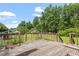 Wooden back deck overlooking a spacious backyard with mature trees at 34 Scotts Creek Run, Angier, NC 27501