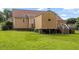The backyard features a lush lawn and mature trees, offering a serene outdoor space at 34 Scotts Creek Run, Angier, NC 27501