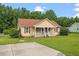 Well-kept single-story home with a spacious front yard and inviting curb appeal at 34 Scotts Creek Run, Angier, NC 27501