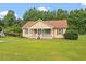 Charming single-story home with a well-manicured lawn and mature trees at 34 Scotts Creek Run, Angier, NC 27501