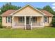 Charming single-story home with a cozy front porch and manicured lawn at 34 Scotts Creek Run, Angier, NC 27501