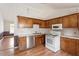 Traditional kitchen with wood cabinets, stainless steel dishwasher, and white oven at 34 Scotts Creek Run, Angier, NC 27501